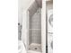 Bathroom shower stall, tiled, with stacked washer and dryer at 4224 N Clay St, Denver, CO 80211
