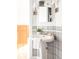 Close up of bathroom pedestal sink with decorative tile and vanity lighting at 4224 N Clay St, Denver, CO 80211