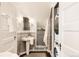 Well-lit bathroom with a pedestal sink and stacked washer and dryer at 4224 N Clay St, Denver, CO 80211