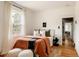 Cozy bedroom with hardwood floors, a comfortable bed, and plenty of natural light at 4224 N Clay St, Denver, CO 80211