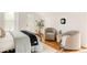 Bright bedroom with two cozy chairs and access to a balcony at 4224 N Clay St, Denver, CO 80211