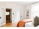 Bedroom with hardwood floors, double doors, ladder with decor, and a large window with natural light at 4224 N Clay St, Denver, CO 80211