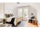 Light and airy bedroom with a large window, hardwood floors and soft decor at 4224 N Clay St, Denver, CO 80211