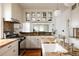 Open-concept kitchen featuring granite countertops, stainless steel appliances, and white cabinetry at 4224 N Clay St, Denver, CO 80211