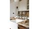 Close-up of a kitchen sink with granite countertops, brushed metal faucet, and white cabinetry at 4224 N Clay St, Denver, CO 80211