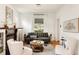Bright living room with a gray sofa, hardwood floors, fireplace, and natural light from a window at 4224 N Clay St, Denver, CO 80211