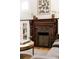 Living room featuring a decorative fireplace with wooden mantle and an art piece above at 4224 N Clay St, Denver, CO 80211