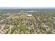 Expansive aerial view of a suburban community with mature trees, a park, and a distant lake at 16149 E Rice Pl # A, Aurora, CO 80015