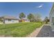 Spacious grassy backyard surrounded by wood fences and leading to neighboring houses at 16149 E Rice Pl # A, Aurora, CO 80015