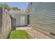 Exterior view of the backyard with stone landscaping, vinyl siding, and a weathered wooden fence at 16149 E Rice Pl # A, Aurora, CO 80015