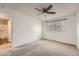 A bright bedroom featuring a ceiling fan, one window and ensuite bathroom at 16149 E Rice Pl # A, Aurora, CO 80015