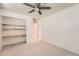 Bright bedroom featuring a ceiling fan and closet with built in wooden shelves at 16149 E Rice Pl # A, Aurora, CO 80015