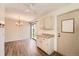 Well-lit dining area with wood floors, stylish chandelier and sliding door to outside at 16149 E Rice Pl # A, Aurora, CO 80015