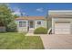 Charming single-story home with light green siding, well-kept lawn, and a detached single car garage at 16149 E Rice Pl # A, Aurora, CO 80015