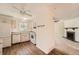 Well-lit kitchen features white cabinets, wood-look flooring, and a view into the living room at 16149 E Rice Pl # A, Aurora, CO 80015