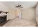 Spacious living room featuring a fireplace, ceiling fan, and neutral carpet, ideal for relaxing or entertaining at 16149 E Rice Pl # A, Aurora, CO 80015