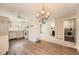 Open floor plan with modern kitchen, fireplace, and laundry area, all seamlessly connected at 16149 E Rice Pl # A, Aurora, CO 80015