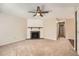 Cozy living room featuring a ceiling fan, plush carpeting, and a classic fireplace with a mantel at 16149 E Rice Pl # A, Aurora, CO 80015