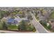 Residential aerial view showcasing a landscaped yard, mature trees, and well-maintained neighborhood streets at 9391 W Hialeah Pl, Littleton, CO 80123