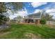 Expansive backyard with deck, covered patio, trampoline and mature trees for outdoor enjoyment at 9391 W Hialeah Pl, Littleton, CO 80123