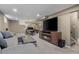 Spacious finished basement with a large sectional sofa, fireplace, and dedicated workspace at 9391 W Hialeah Pl, Littleton, CO 80123