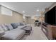 Inviting finished basement featuring a sectional sofa, fireplace, and a functional workstation at 9391 W Hialeah Pl, Littleton, CO 80123