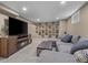 Finished basement with a comfortable sectional sofa, fireplace, and a collection of comic book art at 9391 W Hialeah Pl, Littleton, CO 80123