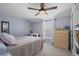 Comfortable bedroom with a light purple walls, large window and stylish accents at 9391 W Hialeah Pl, Littleton, CO 80123