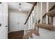 Inviting entryway featuring hardwood floors, a staircase, and double front doors at 9391 W Hialeah Pl, Littleton, CO 80123