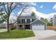 Charming two-story home with a well-manicured lawn and classic architectural details at 9391 W Hialeah Pl, Littleton, CO 80123