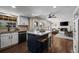 Bright kitchen with island seating and flows into an open living space at 9391 W Hialeah Pl, Littleton, CO 80123