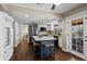Bright kitchen features a blue island with seating, stainless steel appliances, and hardwood floors at 9391 W Hialeah Pl, Littleton, CO 80123