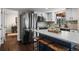 Stainless steel refrigerator and island with seating. Open floor plan at 9391 W Hialeah Pl, Littleton, CO 80123