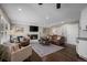 Cozy living room showcasing a brick fireplace, plush seating, and lots of light at 9391 W Hialeah Pl, Littleton, CO 80123