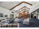 Spacious living room featuring high ceilings, exposed beams, a fireplace, and comfortable seating at 9391 W Hialeah Pl, Littleton, CO 80123