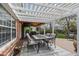 Inviting outdoor dining area with table, chairs, pergola, and stylish rug for relaxing outdoor meals at 9391 W Hialeah Pl, Littleton, CO 80123