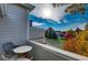Charming balcony view features outdoor seating overlooking the street and neighborhood's vibrant fall foliage under sunny skies at 10380 W 55Th Ln # 204, Arvada, CO 80002