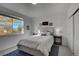 Cozy bedroom featuring a bright window, a plush queen bed, and soft lighting fixtures at 10380 W 55Th Ln # 204, Arvada, CO 80002