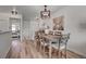 Dining area featuring a large wooden table, chandelier, and access to other areas of the home at 10380 W 55Th Ln # 204, Arvada, CO 80002