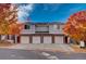 Charming townhouse with brick facade, attached garages, and colorful autumn foliage at 10380 W 55Th Ln # 204, Arvada, CO 80002