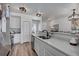 Bright kitchen features white cabinets, stainless steel appliances, and a breakfast bar with stone countertop at 10380 W 55Th Ln # 204, Arvada, CO 80002