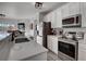 Open concept kitchen with stainless steel appliances, white cabinets, and seamless transition to the dining area at 10380 W 55Th Ln # 204, Arvada, CO 80002