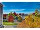 Beautiful street view showcases colorful fall foliage and well-maintained homes under a bright, clear sky at 10380 W 55Th Ln # 204, Arvada, CO 80002