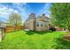 Well-maintained lawn highlights the home's backyard, enhanced by a wooden fence and mature trees at 12433 Bellaire Dr, Thornton, CO 80241