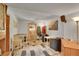 Finished basement area with a bar, tables, and comfortable seating at 12433 Bellaire Dr, Thornton, CO 80241