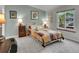 Cozy bedroom featuring a patchwork quilt, side tables with lamps, and natural light at 12433 Bellaire Dr, Thornton, CO 80241
