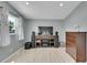 A media room with a wall-mounted TV, speakers, and a dresser for storage at 12433 Bellaire Dr, Thornton, CO 80241