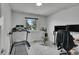 Bedroom with workout equipment including a treadmill and bike at 12433 Bellaire Dr, Thornton, CO 80241