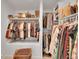 Well-organized walk-in closet featuring shelving and hanging storage for clothes and accessories at 12433 Bellaire Dr, Thornton, CO 80241