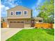 Charming two-story home with well-maintained lawn, mature tree, and a two-car garage at 12433 Bellaire Dr, Thornton, CO 80241
